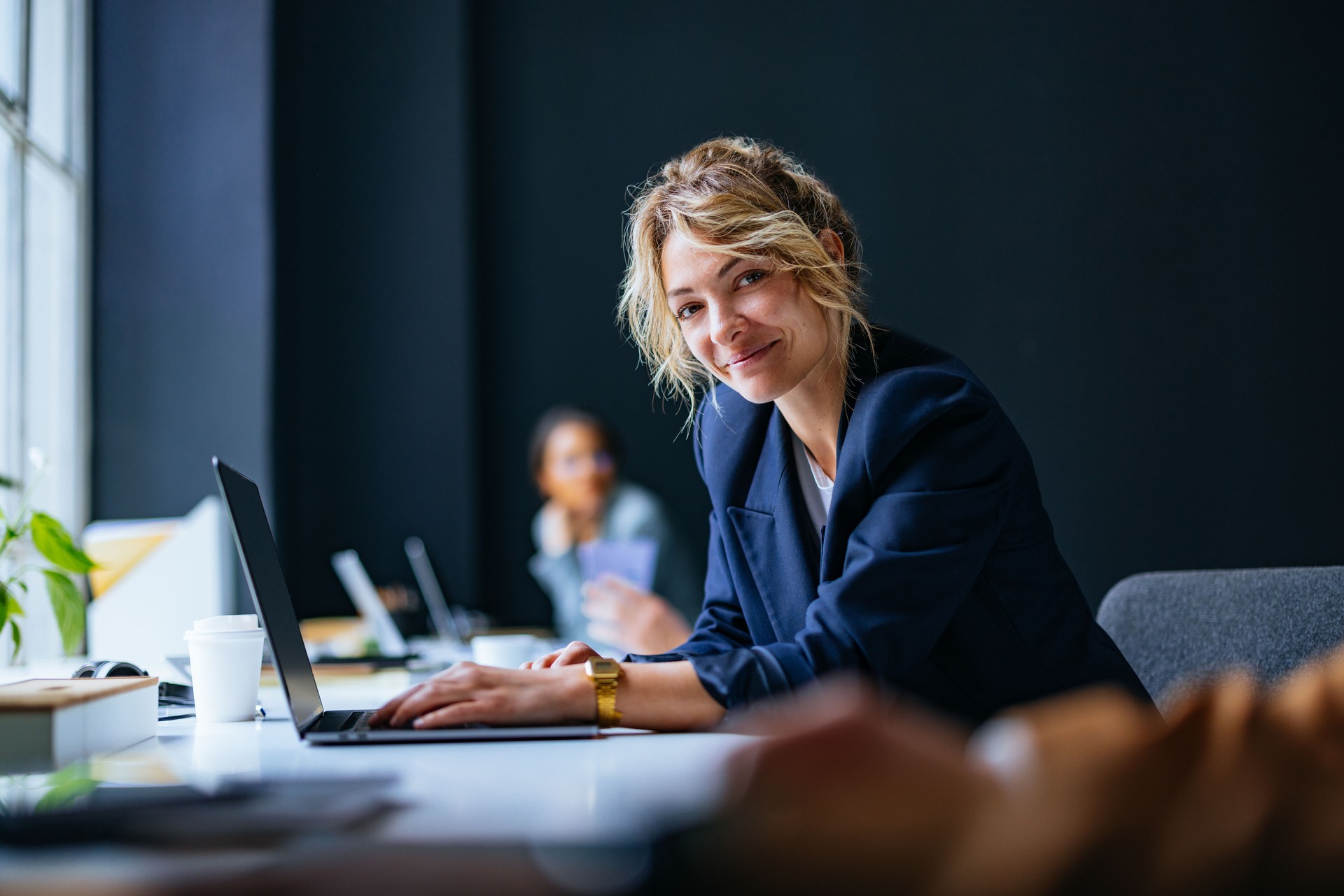 Portrait Of Happy Business Woman Sitting In The Office